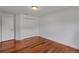 Bedroom featuring hardwood floors, a closet and white walls at 12713 Pine Arbor Dr, Clermont, FL 34711