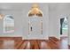 Welcoming front entry foyer featuring hardwood floors, chandelier and arched doorway at 12713 Pine Arbor Dr, Clermont, FL 34711
