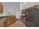 Traditional kitchen boasts stainless steel appliances, wood cabinets and tile floors at 12713 Pine Arbor Dr, Clermont, FL 34711
