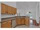 Galley kitchen with light-toned cabinets and stainless steel dishwasher at 12713 Pine Arbor Dr, Clermont, FL 34711