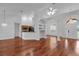 Spacious room featuring hardwood floors, kitchen, columns and arched doorways at 12713 Pine Arbor Dr, Clermont, FL 34711