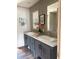Bathroom features dual sinks with gray cabinets, sleek hardware, and modern mirrors at 1349 Nw 109 Ave, Ocala, FL 34482