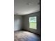 Bright and airy bedroom with new flooring and a large window offering natural light at 1349 Nw 109 Ave, Ocala, FL 34482
