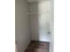 Compact closet with laminate flooring and a single shelf, ready for organization at 1349 Nw 109 Ave, Ocala, FL 34482