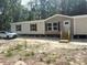 Well-maintained exterior showcasing a cozy single-story home with a clean aesthetic at 1349 Nw 109 Ave, Ocala, FL 34482