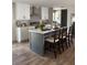 Modern kitchen with white cabinets, a gray island, and stainless steel appliances at 1349 Nw 109 Ave, Ocala, FL 34482