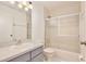 Bathroom showcasing a single sink vanity and a shower over tub with glass sliding doors at 14063 Ithaca Way, Orlando, FL 32826