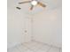 Bedroom featuring white walls, white tile flooring, ceiling fan and closet at 14063 Ithaca Way, Orlando, FL 32826