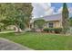 Well-manicured front yard featuring lush green grass, mature landscaping, and an inviting single-story home at 14063 Ithaca Way, Orlando, FL 32826