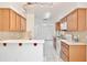 Well-equipped kitchen with ample wood cabinetry, white appliances, and a functional layout for cooking at 14063 Ithaca Way, Orlando, FL 32826