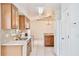 Bright kitchen with stainless steel appliances, light wood cabinets, and white tile flooring at 14063 Ithaca Way, Orlando, FL 32826