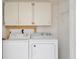 Laundry room featuring white washer and dryer units and above-unit storage at 14063 Ithaca Way, Orlando, FL 32826