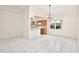 Open concept living room showcasing tiled floors, natural light, and seamless flow to the adjacent kitchen at 14063 Ithaca Way, Orlando, FL 32826