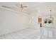 Bright and airy living room features tiled floors, high ceilings, and a view of the kitchen and dining area at 14063 Ithaca Way, Orlando, FL 32826
