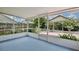 An inviting screened-in patio with blue flooring and views of the backyard at 14063 Ithaca Way, Orlando, FL 32826