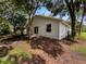 Home's backyard featuring large trees at 142 E 9Th St, Chuluota, FL 32766