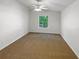 Bright, empty bedroom featuring vaulted ceiling and plush carpeting at 142 E 9Th St, Chuluota, FL 32766