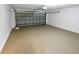 Spacious two-car garage with epoxy-coated concrete floors and an insulated garage door at 142 E 9Th St, Chuluota, FL 32766
