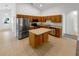Open kitchen features stainless steel appliances, an island, and ample cabinet space at 142 E 9Th St, Chuluota, FL 32766