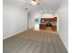 Open concept living room flows into the kitchen with tile and carpet flooring and modern lighting fixtures at 142 E 9Th St, Chuluota, FL 32766