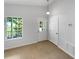 Mud room with tile floors, a window overlooking greenery, white doors, and access to a side yard at 142 E 9Th St, Chuluota, FL 32766