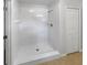All-white walk-in shower with glass door and tiled surround, offering a modern and clean look at 142 E 9Th St, Chuluota, FL 32766