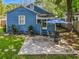 Backyard patio area with a blue umbrella, table, and chairs next to the house at 1642 Mount Vernon St, Orlando, FL 32803
