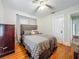Comfortable bedroom with ceiling fan, hardwood floors, and a cozy bed at 1642 Mount Vernon St, Orlando, FL 32803