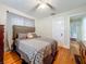 Bedroom featuring ceiling fan, hardwood floors, and comfortable bed at 1642 Mount Vernon St, Orlando, FL 32803