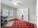 Bedroom with a red and white rug, light walls and a door looking into another room at 1642 Mount Vernon St, Orlando, FL 32803