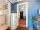 Hallway with blue walls leading to a bedroom with a red rug at 1642 Mount Vernon St, Orlando, FL 32803