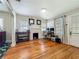 Cozy living room with hardwood floors, a painted fireplace, and large windows, offering a bright and welcoming atmosphere at 1642 Mount Vernon St, Orlando, FL 32803