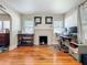 Inviting living room with hardwood floors, a white fireplace, and ample natural light, perfect for comfortable living and relaxation at 1642 Mount Vernon St, Orlando, FL 32803