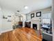 Warm living room featuring hardwood floors, a charming brick fireplace, and natural light, creating a cozy and inviting space at 1642 Mount Vernon St, Orlando, FL 32803