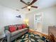 Cozy living space with ceiling fan, plush sofa, and Virginia JMU wall decor at 1642 Mount Vernon St, Orlando, FL 32803
