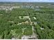 Expansive aerial view of properties nestled among lush trees near a tranquil lake and neighborhood at 18166 Lynbrook Rd, Orlando, FL 32820