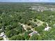 Overhead shot displaying the property's serene setting, surrounded by verdant trees near residential areas and a lake at 18166 Lynbrook Rd, Orlando, FL 32820