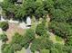 Aerial view of a home enveloped by towering trees on a large plot of land at 18166 Lynbrook Rd, Orlando, FL 32820