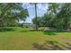 Vast backyard featuring a well-maintained lawn and distant views of a charming single-story home at 18166 Lynbrook Rd, Orlando, FL 32820