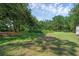Large grassy backyard shaded by mature trees, offering a private and serene outdoor space at 18166 Lynbrook Rd, Orlando, FL 32820