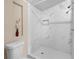 Modern bathroom featuring a tiled shower with marble walls and an ornate white flower pot at 18166 Lynbrook Rd, Orlando, FL 32820