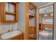 Hallway and partial bath featuring a small sink with a view into another room at 18166 Lynbrook Rd, Orlando, FL 32820