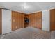 Bedroom featuring wood paneling, built in shelving, and ample closet space at 18166 Lynbrook Rd, Orlando, FL 32820