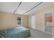 Comfortable bedroom with tile floors and a view into the entryway with an open door at 18166 Lynbrook Rd, Orlando, FL 32820