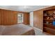 Cozy bedroom with wood paneling, a comfortable bed, and natural light from the window at 18166 Lynbrook Rd, Orlando, FL 32820