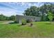 Charming home with green grass, trees, and a rear deck for relaxing and enjoying the outdoors at 18166 Lynbrook Rd, Orlando, FL 32820