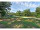 Spacious front yard with a single-story home, long driveway, and lush greenery at 18166 Lynbrook Rd, Orlando, FL 32820