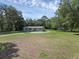Expansive front yard view showcasing the single-story home, mature trees, and well-maintained lawn at 18166 Lynbrook Rd, Orlando, FL 32820