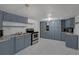 Spacious kitchen with blue cabinets, modern appliances, and plenty of countertop space at 18166 Lynbrook Rd, Orlando, FL 32820