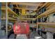 View of the interior of a metal shed with shelves full of boxes and yard equipment at 18166 Lynbrook Rd, Orlando, FL 32820